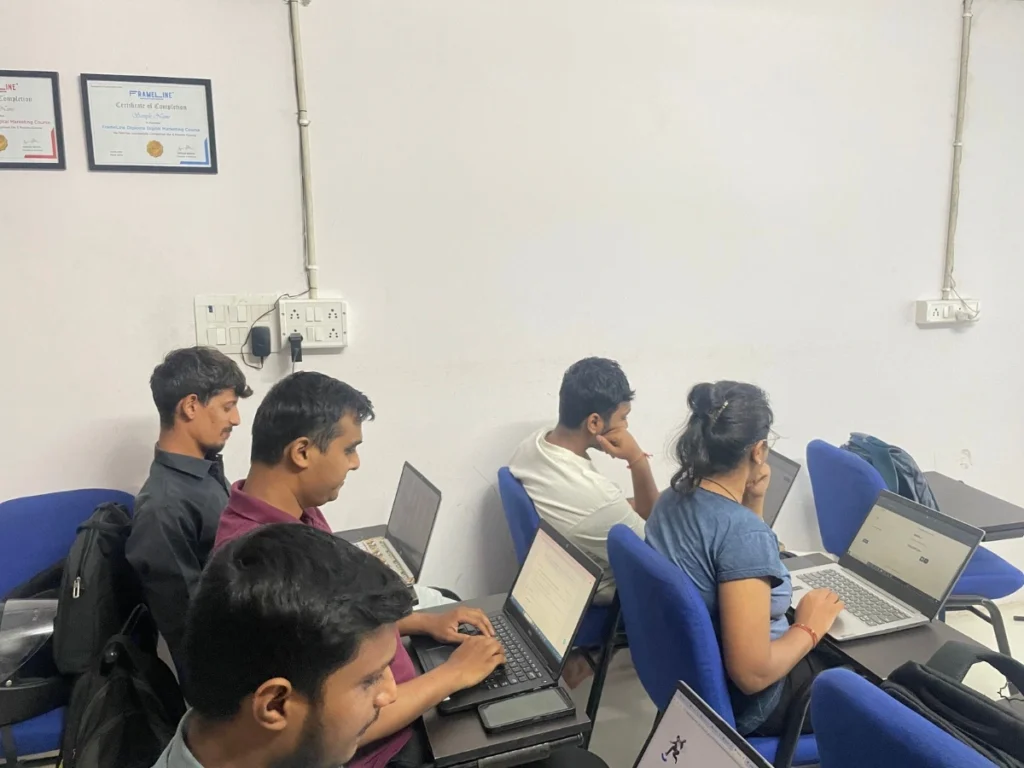 Students focused on their laptops during a learning session in a classroom, with certificates proudly displayed on the wall—highlighting a practical and engaging digital marketing course after 12th.
